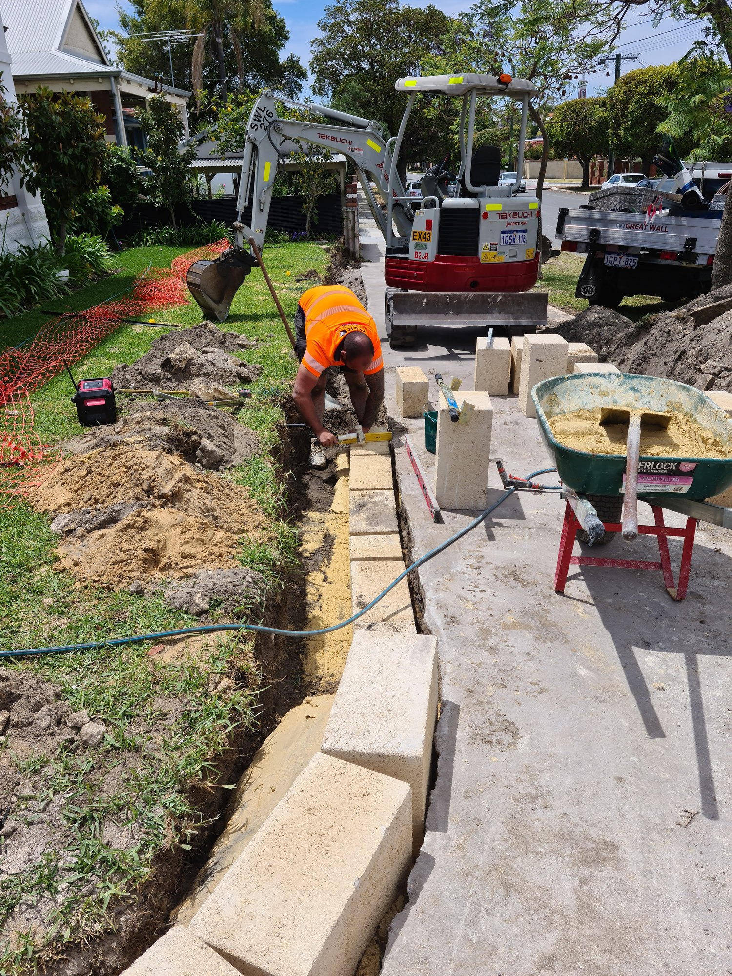 Excavator on site completing earthworks and excavation support works.