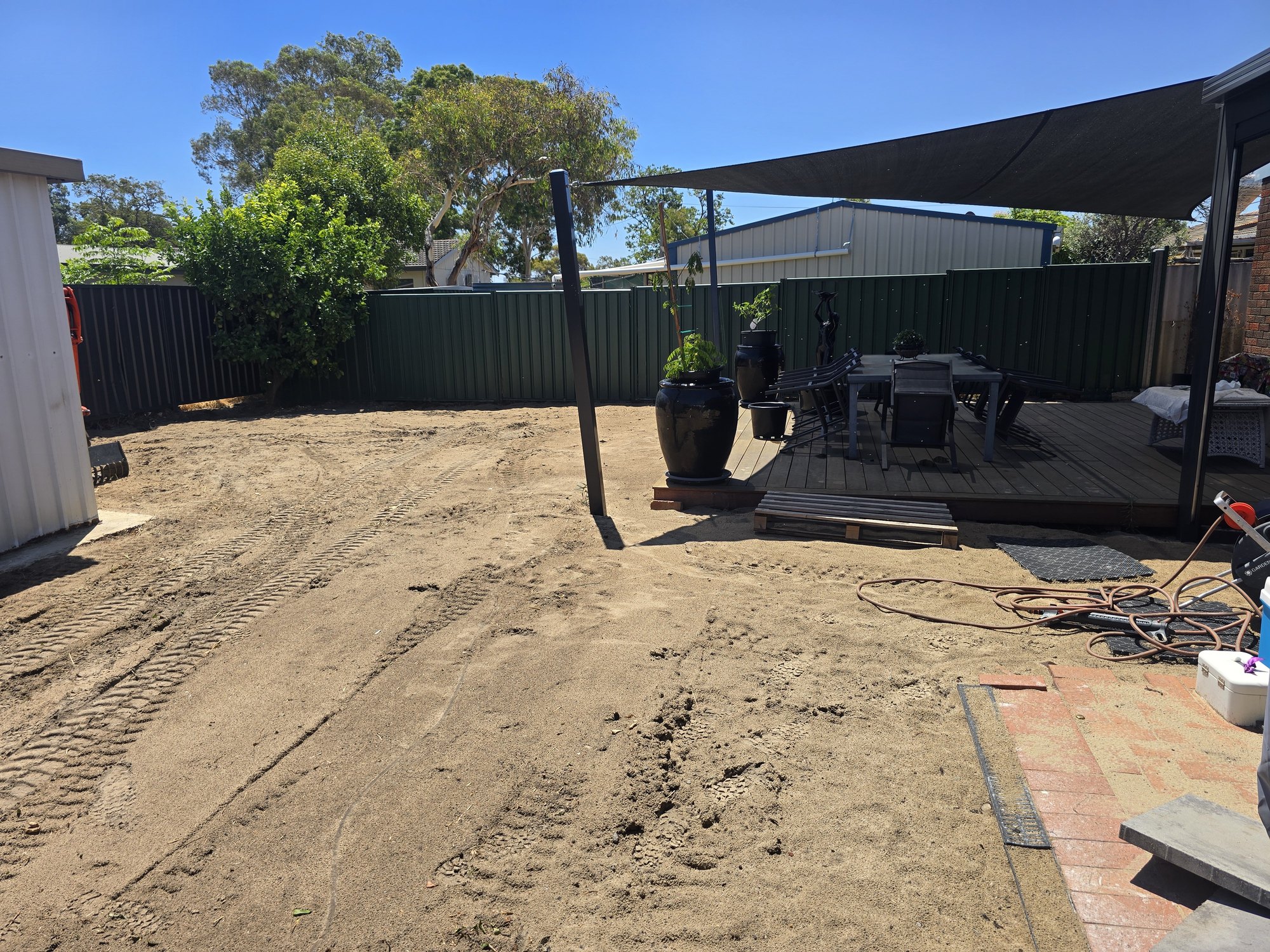 Site preparation works underway with machinery on site.