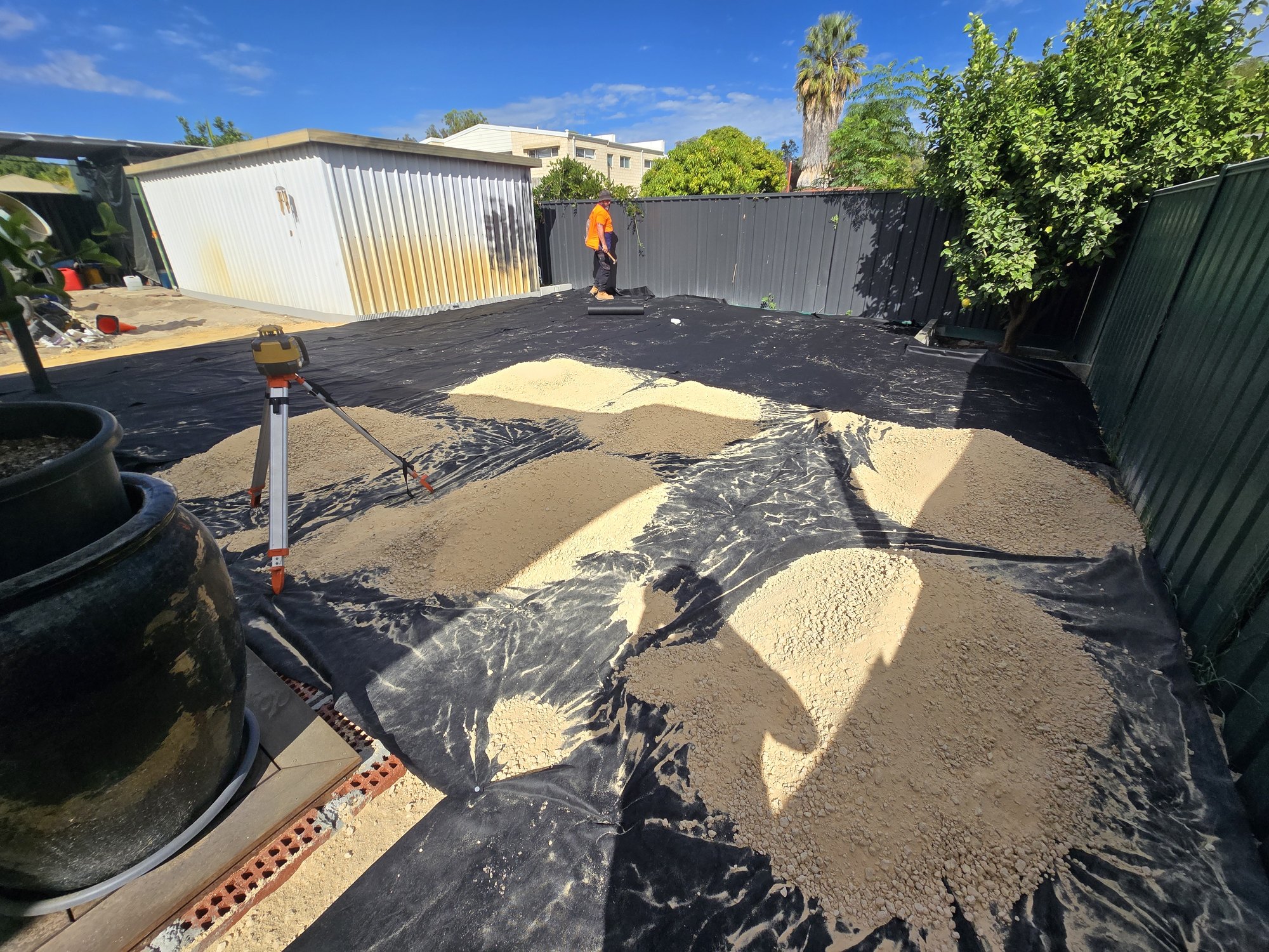 Material being spread and levelled across the site.